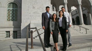Four USC Price students standing in front of City Hall