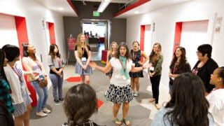 Girls in a circle smiling and laughing