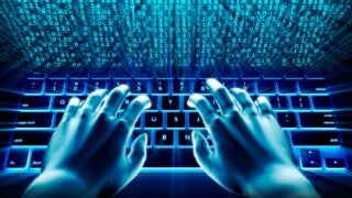 Hands typing on computer