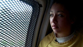 Woman looking outside gated window