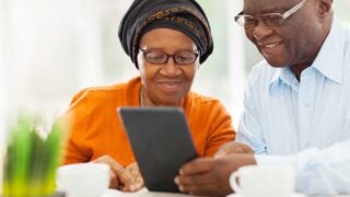 Two people looking at tablet together