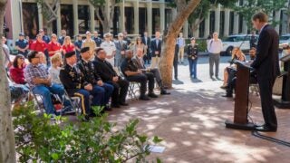 Dean Jack H. Knott speaks in front of an audience at the 9/11 commemorative service
