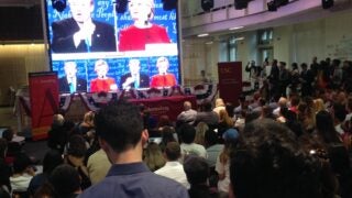 Debate on television screen between Donald Trump and Hilary Clinton