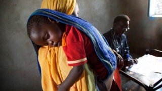 Mother holding boy in her arms