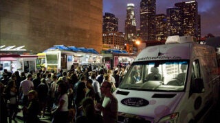 Foodtrucks at night with downtown skyline in background