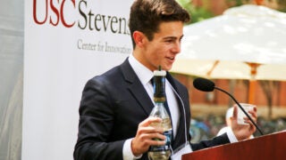 Student delivering business pitch behind podium