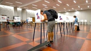 Polling station with student and skateboard casting his vote