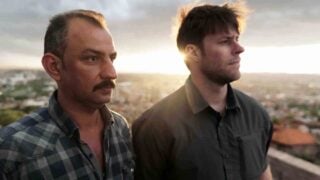 Two men standing next to each other