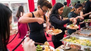Students serving themselves food in a buffet line
