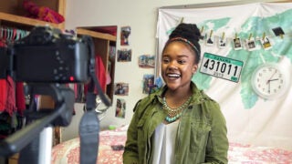 Joi Wade, a student behind a film camera