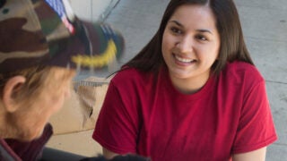 Female social worker helping homeless man