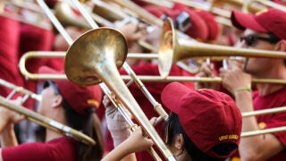 Members of Trojan Marching Band playing trombone