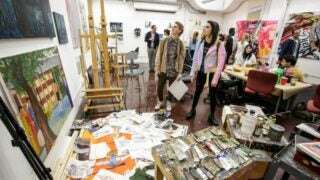 Students admiring other students' artwork