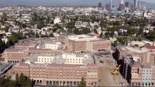 Aerial view of USC Village and LA skyline and mountains