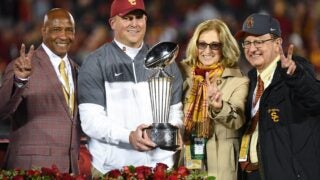 Lynn Swann holding Rose Bowl trophy