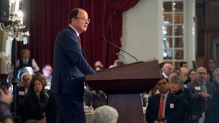 C. L. Max Nikias at a podium