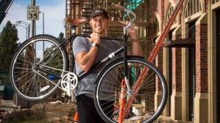 Brian Ruben holding bicycle