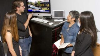male pointing at computer screen