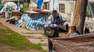 woman speaking to a homeless individual
