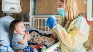 Kimberly Grenawitzke working with a baby