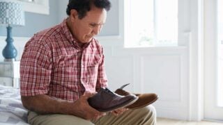 elderly male looking at shoes