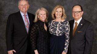 From left: USC Board of Trustees Chair John Mork and his wife, Julie Mork, with Niki C. Nikias and C. L. Max Nikias