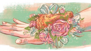 A fried chicken prom corsage on a hand