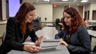 lawyer reviewing documents with client