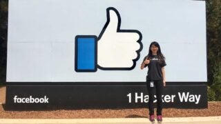 Qinqin Zhu in front of facebook sign