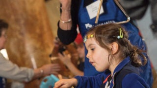 Women and small child explore and try out instruments