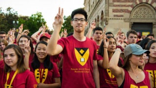 Students flash the victory sign at the Residential College Spirit Rally.