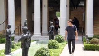 male walking through Getty Villa