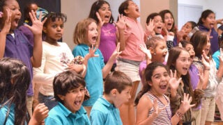 Children in making faces as they are happily lined up