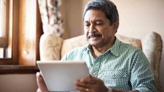 elderly male using a tablet device