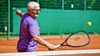 elderly man playing tennis