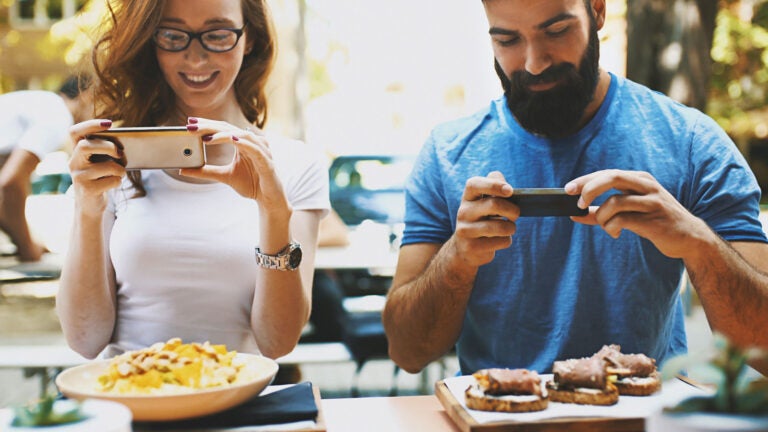 couple taking photo of food