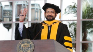 Siddhartha Mukherjee standing at a podium