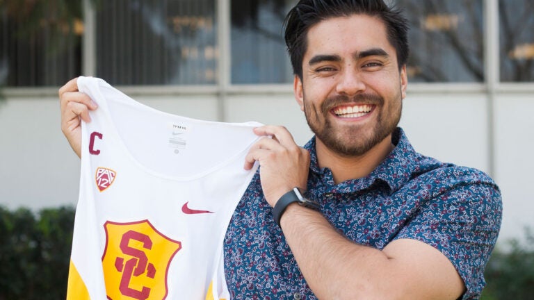 Diego Lopez holding track uniform