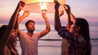 individuals carrying a lantern