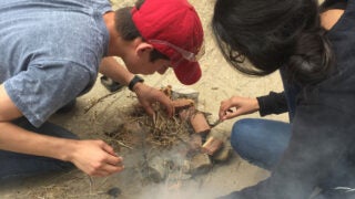 students creating a fire
