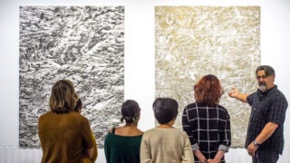 students at an art exhibit