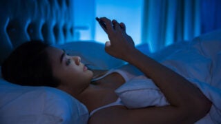 teen using phone at night