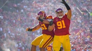 Brandon Pili celebrates with teammate