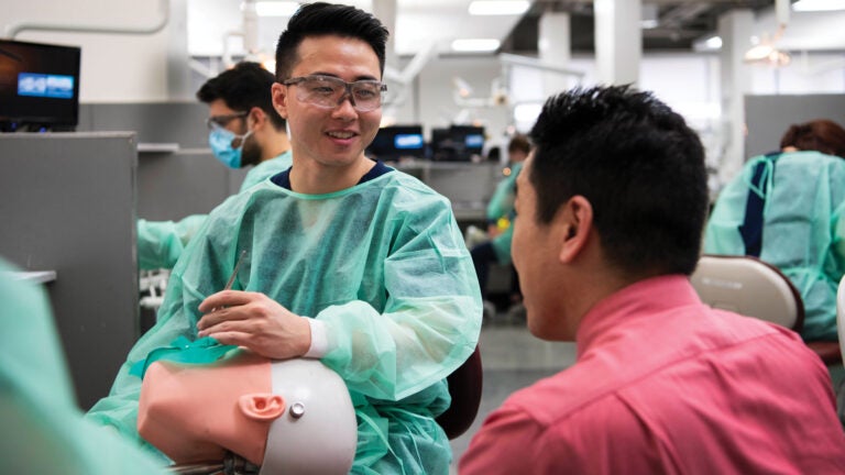 Nicholas Tan, left, learns the importance of proper ergonomics and building solid habits from instructor Kenneth Kim.