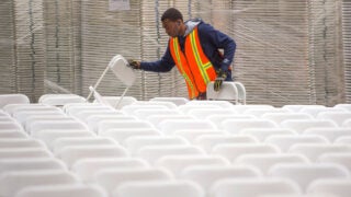 Work crews lay out chairs in preparation for the 2016 commencement ceremony at USC. (USC Photo/Gus Ruelas)