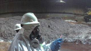 A worker investigates at the Exide facility, which released 3,500 tons of lead until it closed as part of a legal settlement for its hazardous waste production. (Photo/Department of Toxic Substances Control)