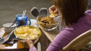 Woman eating cookies and chips