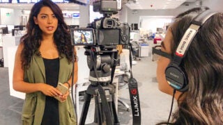 Reporter speaking in front of a camera