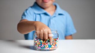 child grabbing candy