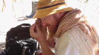 Erik Seiffert identifying a small fossil from the Santa Rosa site where Ucayalipithecus was found, in Amazonian Perú.